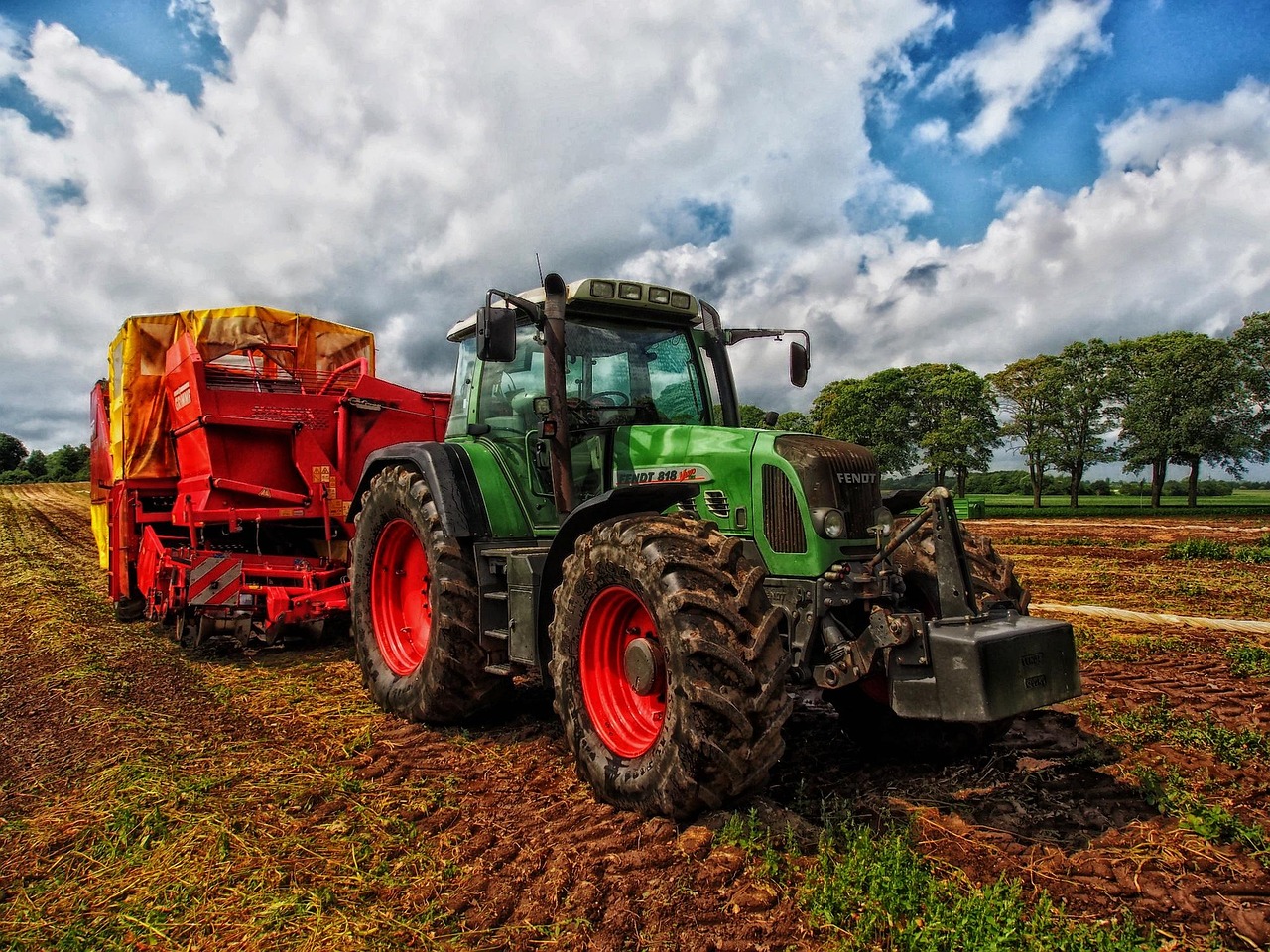 Mechanic repairing a tractor outdoors